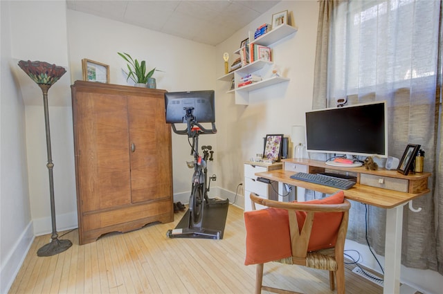 home office with baseboards and hardwood / wood-style floors