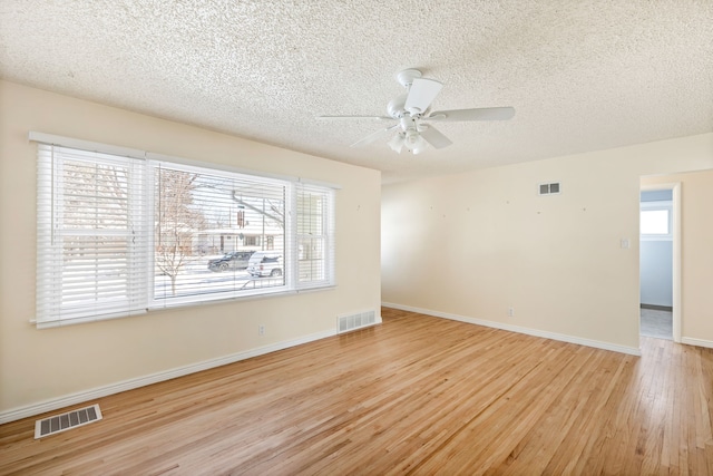 spare room featuring ceiling fan, a textured ceiling, and light wood-type flooring