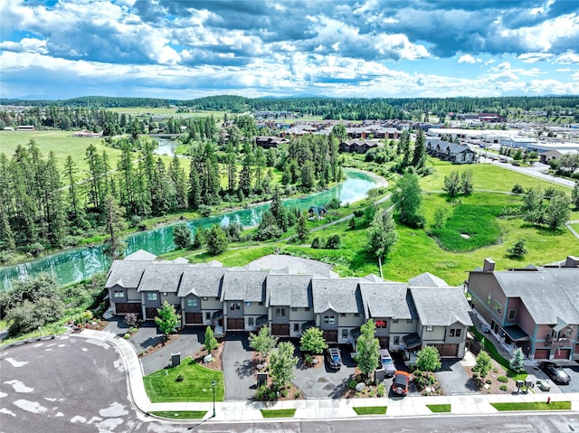 drone / aerial view with a water view and a residential view