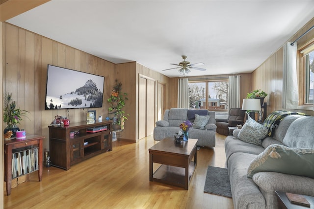 living room with ceiling fan and light wood-type flooring