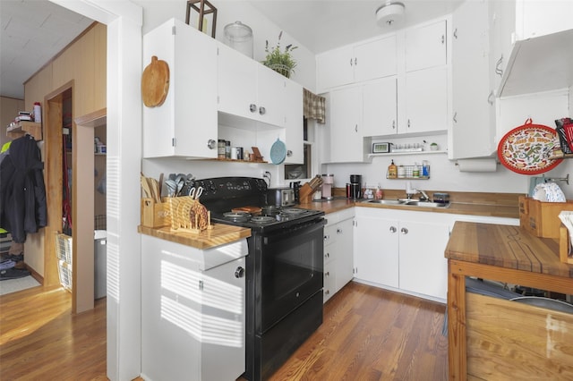 kitchen with white cabinetry, sink, dark hardwood / wood-style flooring, and black / electric stove