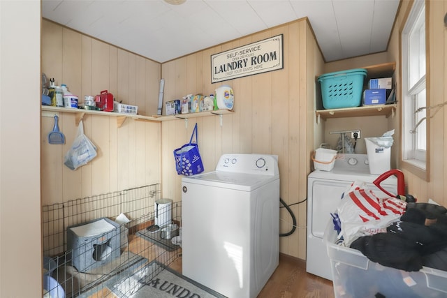 laundry room with dark hardwood / wood-style flooring and washing machine and dryer