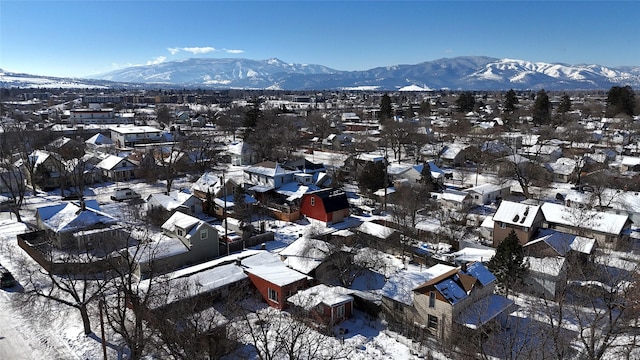 snowy aerial view featuring a mountain view