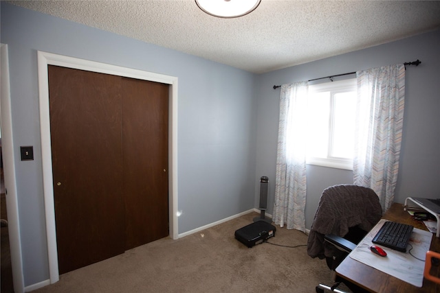 office space with a textured ceiling and carpet