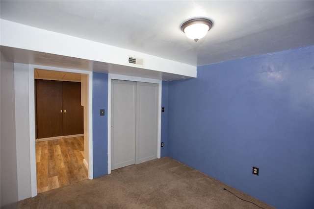 unfurnished bedroom featuring carpet floors and a closet