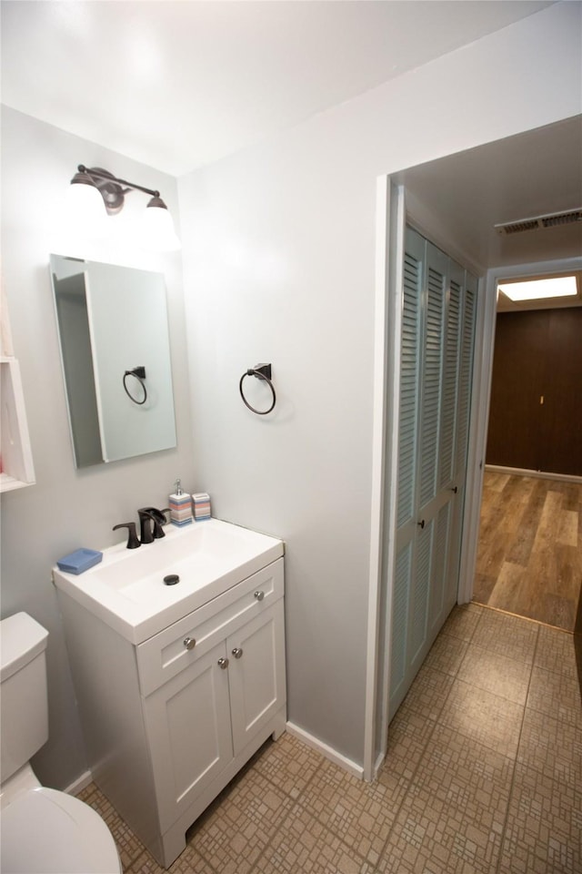 bathroom with vanity and toilet