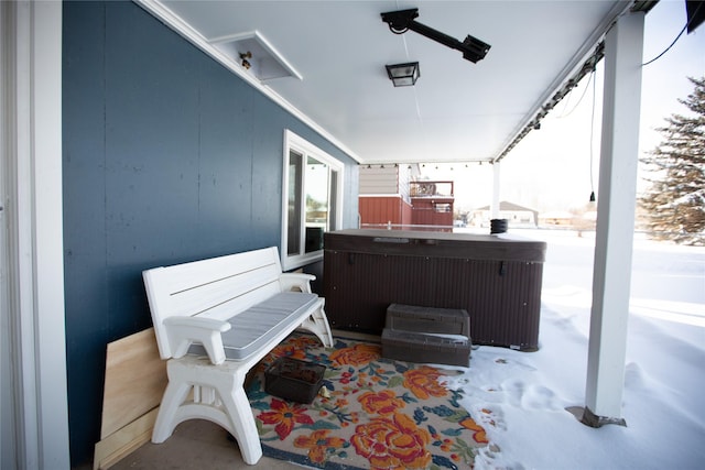 snow covered patio featuring a hot tub