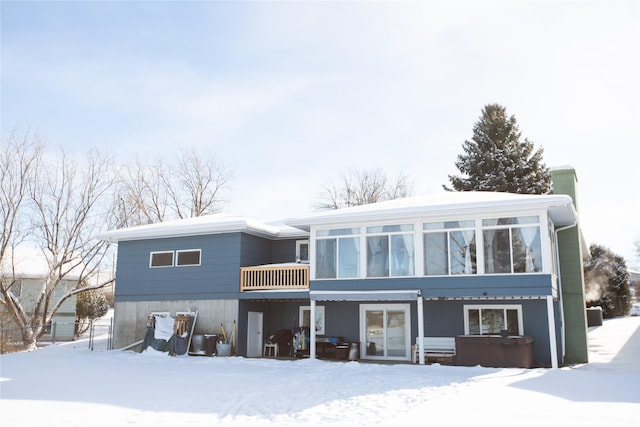 snow covered property featuring a jacuzzi