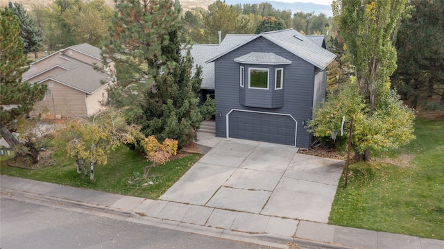 view of front of property with a garage and a front yard