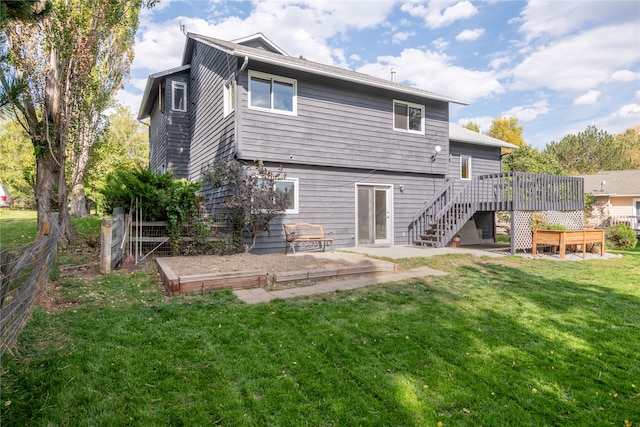 rear view of property with a wooden deck and a yard