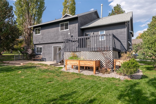 rear view of house featuring a yard, a patio area, and a deck