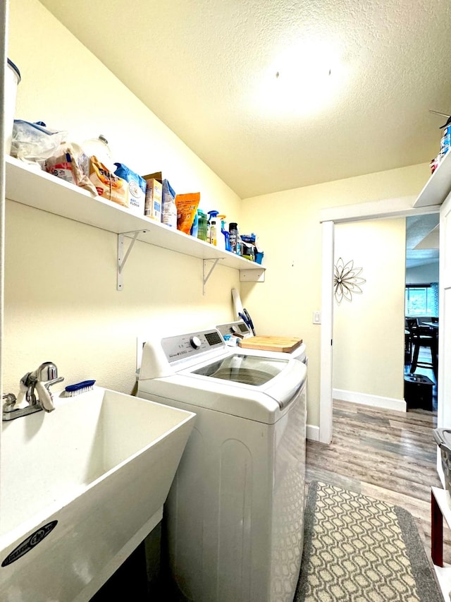 66 Moccasin Ln, Thompson Falls, MT 59873 - washroom with washer and dryer, light wood-style flooring, a textured ceiling, and baseboards