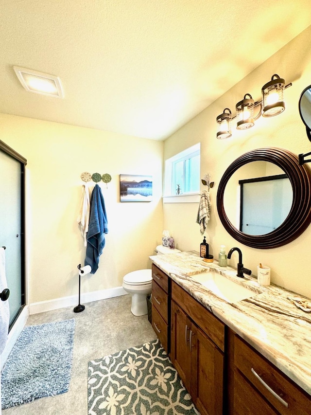 66 Moccasin Ln, Thompson Falls, MT 59873 - bathroom featuring vanity, a stall shower, toilet, and baseboards