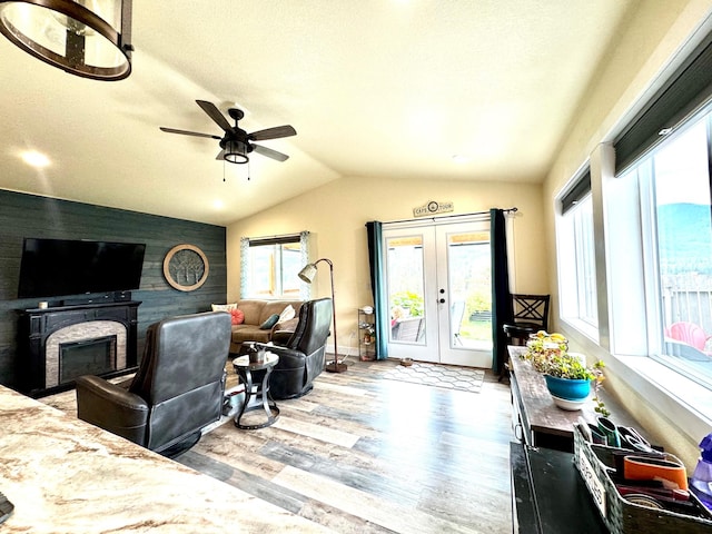 66 Moccasin Ln, Thompson Falls, MT 59873 - living area with wood finished floors, a ceiling fan, french doors, vaulted ceiling, and an accent wall