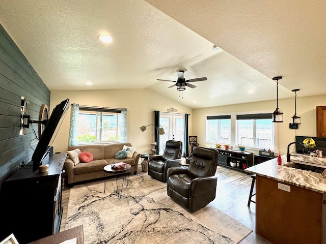 66 Moccasin Ln, Thompson Falls, MT 59873 - living area featuring a textured ceiling, lofted ceiling, a ceiling fan, wood finished floors, and recessed lighting