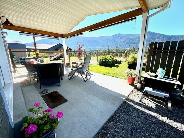 66 Moccasin Ln, Thompson Falls, MT 59873 - fenced backyard featuring a mountain view, a patio area, and outdoor dining space
