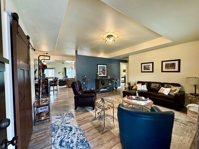 66 Moccasin Ln, Thompson Falls, MT 59873 - living room featuring a barn door and wood finished floors