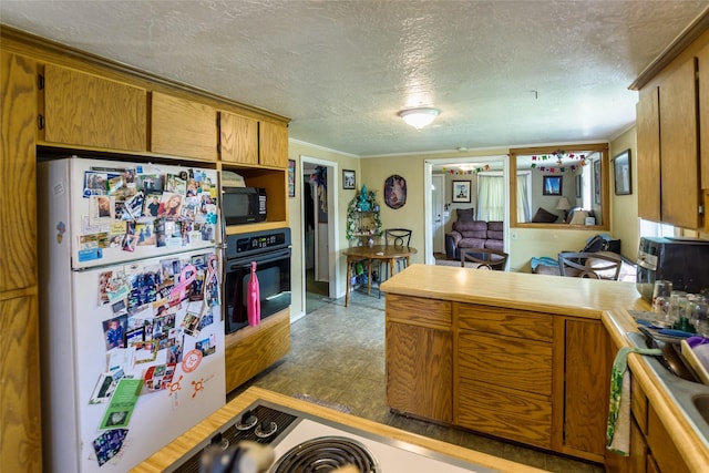 kitchen with crown molding, black appliances, and a textured ceiling