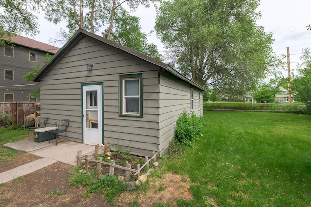 view of outbuilding featuring a lawn