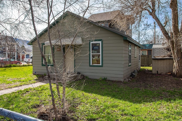 bungalow-style home with a front lawn