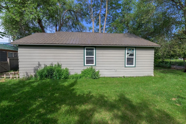 view of side of home with a yard