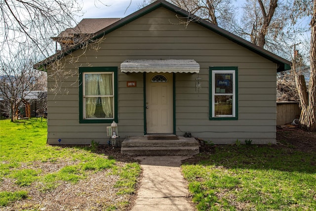 bungalow-style house featuring a front yard