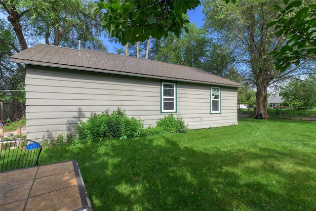 view of home's exterior with a lawn