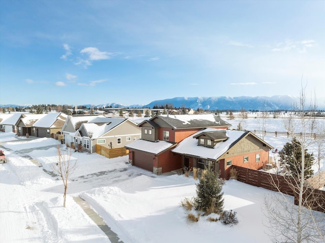 snowy aerial view featuring a mountain view