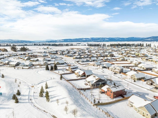 snowy aerial view featuring a mountain view