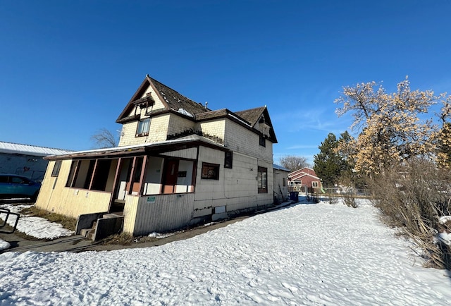 view of snow covered exterior featuring a porch