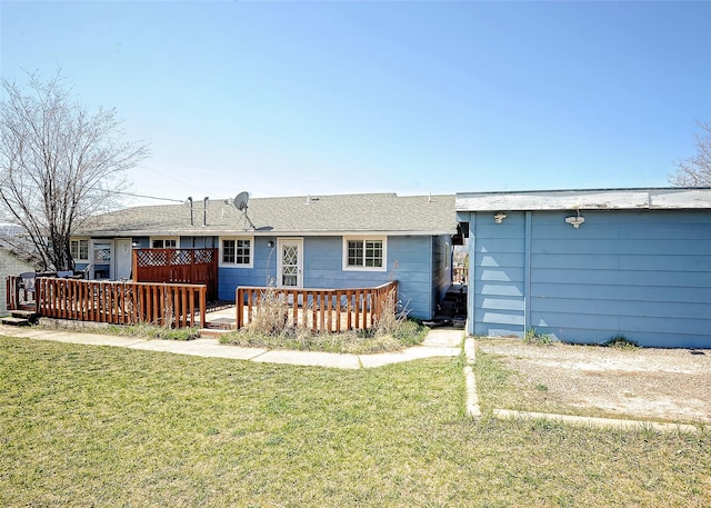 6 Parkway Dr Unit A & B, Kalispell, MT 59901 - rear view of property featuring a lawn and a deck