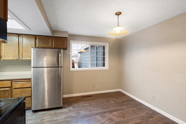 6 Parkway Dr Unit A & B, Kalispell, MT 59901 - kitchen featuring freestanding refrigerator, wood finished floors, black electric range oven, a textured ceiling, and light countertops