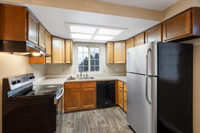 6 Parkway Dr Unit A & B, Kalispell, MT 59901 - kitchen featuring freestanding refrigerator, range with electric stovetop, black dishwasher, light wood-type flooring, and under cabinet range hood