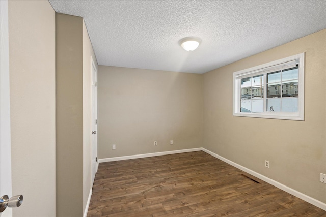 6 Parkway Dr Unit A & B, Kalispell, MT 59901 - empty room featuring dark wood-style floors and a textured ceiling