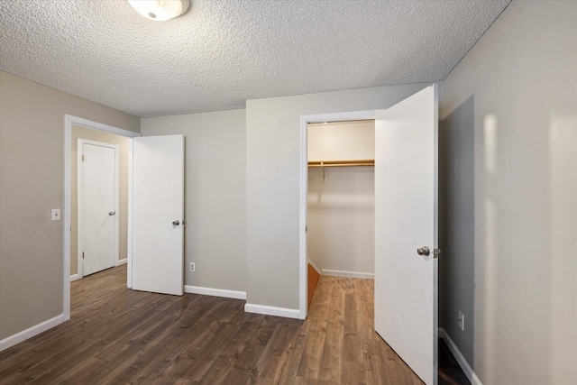 6 Parkway Dr Unit A & B, Kalispell, MT 59901 - unfurnished bedroom featuring dark wood-style floors, a closet, and a textured ceiling