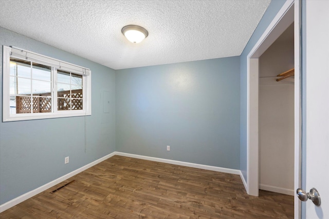 6 Parkway Dr Unit A & B, Kalispell, MT 59901 - unfurnished bedroom featuring a textured ceiling, wood finished floors, and a closet