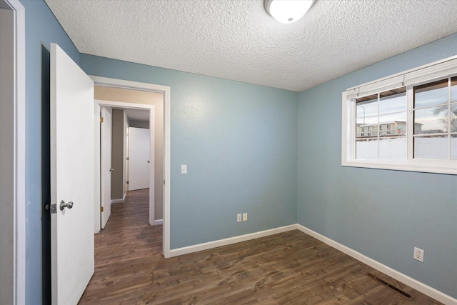 6 Parkway Dr Unit A & B, Kalispell, MT 59901 - empty room with a textured ceiling and dark wood-style flooring