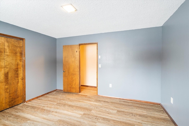 unfurnished bedroom featuring light hardwood / wood-style floors and a textured ceiling