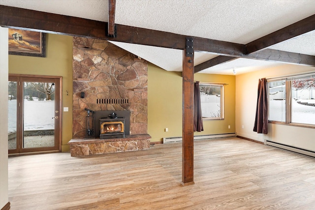 unfurnished living room with beamed ceiling, light hardwood / wood-style floors, and a textured ceiling