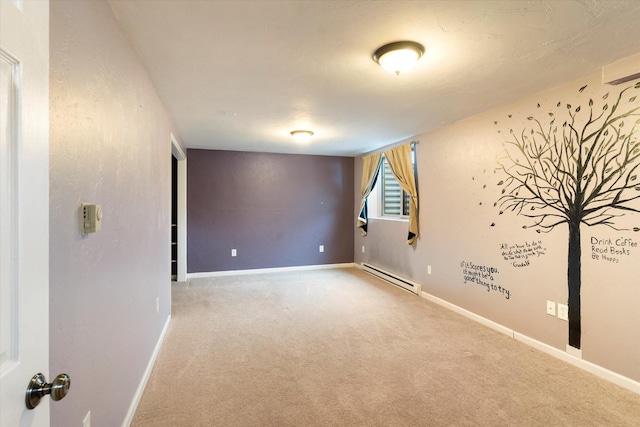 carpeted empty room featuring a baseboard heating unit