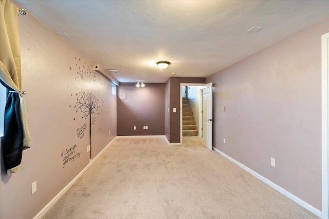 unfurnished room featuring light carpet