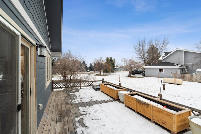 snowy yard with a wooden deck