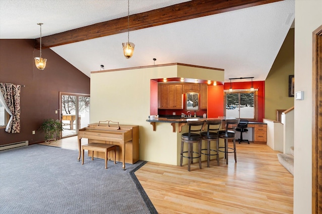 kitchen with pendant lighting, light hardwood / wood-style flooring, a kitchen bar, kitchen peninsula, and beamed ceiling