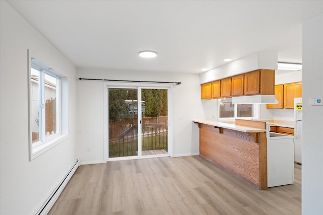 1888 N Belmar Dr, Kalispell, MT 59901 - kitchen with a baseboard heating unit, light wood-type flooring, under cabinet range hood, plenty of natural light, and recessed lighting
