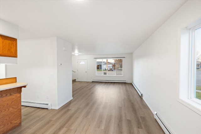 1888 N Belmar Dr, Kalispell, MT 59901 - unfurnished living room featuring a baseboard radiator, light wood-style flooring, and baseboard heating
