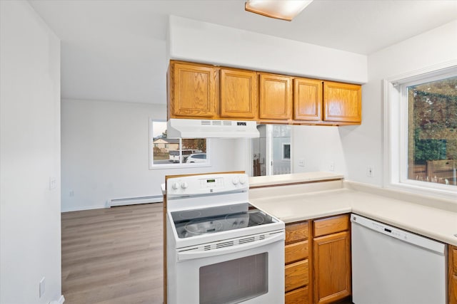 1888 N Belmar Dr, Kalispell, MT 59901 - kitchen with white appliances, under cabinet range hood, light wood finished floors, light countertops, and brown cabinets