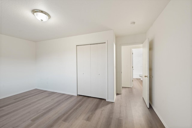 1888 N Belmar Dr, Kalispell, MT 59901 - unfurnished bedroom featuring wood finished floors and a closet