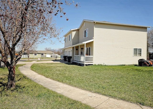 1888 N Belmar Dr, Kalispell, MT 59901 - view of side of property with a yard, covered porch, and a garage
