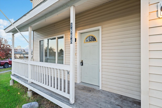 view of exterior entry with covered porch