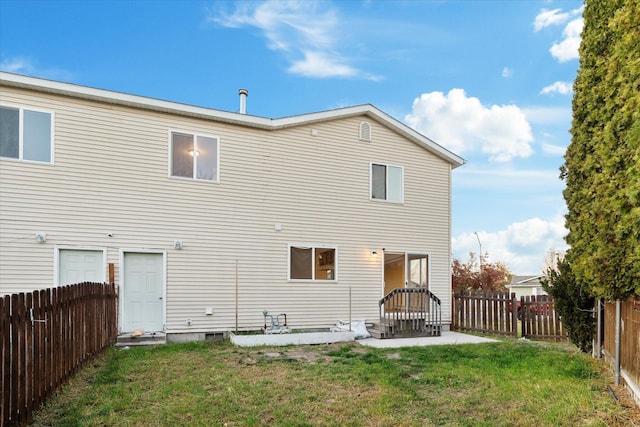 1888 N Belmar Dr, Kalispell, MT 59901 - back of property with a fenced backyard and a patio area